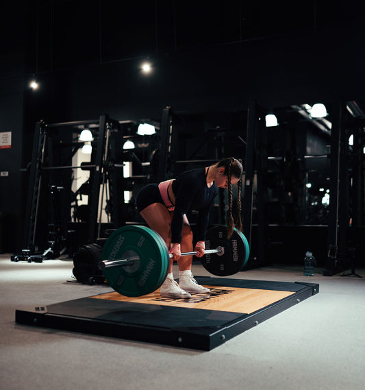 woman doing deadlift with uppper lifting gear