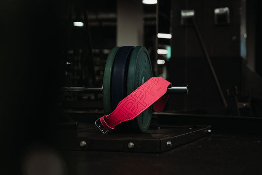 uppper neon pink lifting belt on barbell