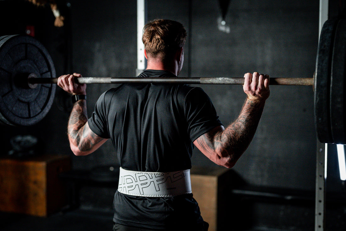 man preparing to do a barbell squat